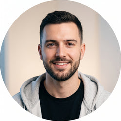 A circular portrait of a smiling man, @studiobuilder, looking at the camera. He has dark hair and a short beard. The backgrou