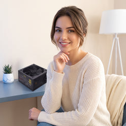 A woman with a confident expression in a clean portrait, representing 'The Aesthetic Rig' influencer. A 1000W PC power supply