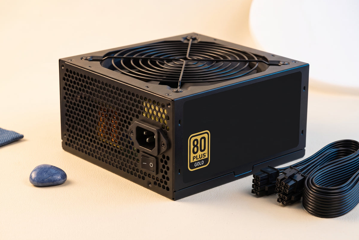 A 1000W fully modular ATX PC power supply with gold accents on a cream surface with soft blue lighting.